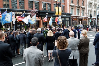 The families of the three people killed in the Boston Marathon bombing explosions — Martin Richard, Krystle Campbell and Lingzi Lu — listen as Cardinal Sean P. O’Malley proclaims a reading from Scripture before wreath-laying at the site of the first explosion April 15, the first anniversary of the attack. With the cardinal were Boston Mayor Martin J. Walsh and his partner Lorrie Higgins and Gov. Deval Patrick and his wife, Diane. (Pilot photo/ Gregory L. Tracy)